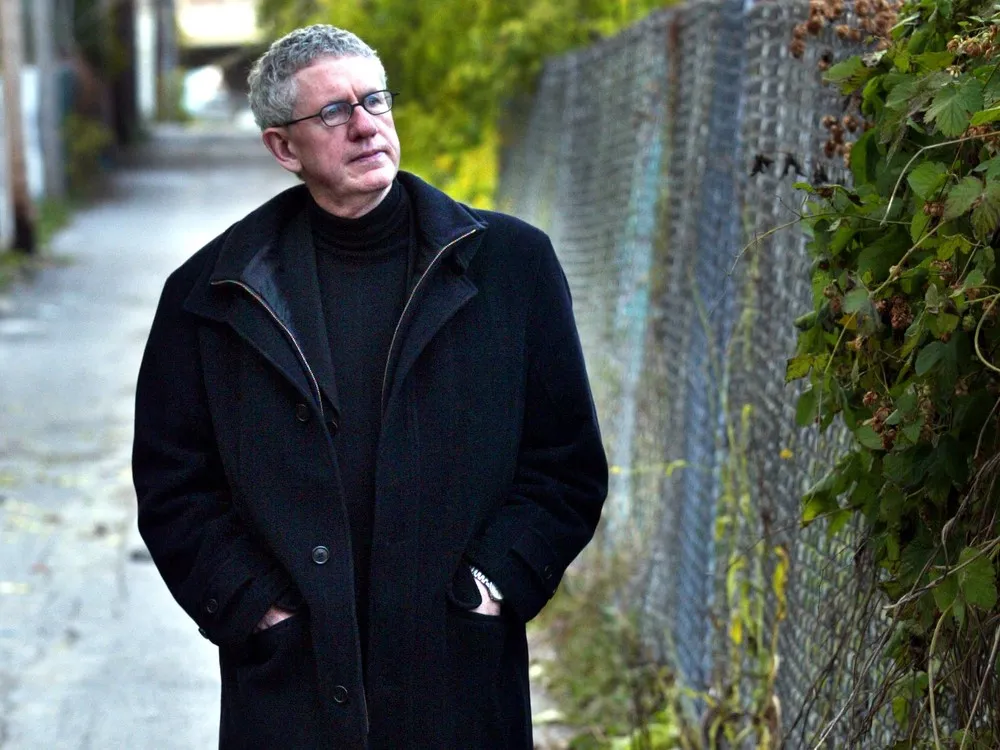 Brian McKenna in long black coat