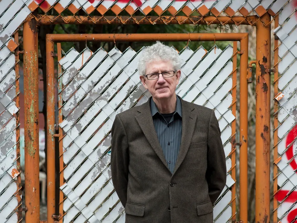 Brian McKenna standing in front of wooden door